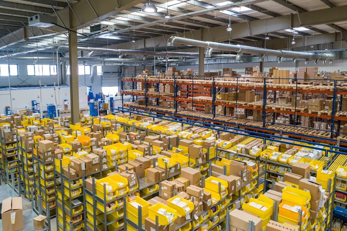 Yellow picking bins and pallet racking on a busy fulfilment centre floor